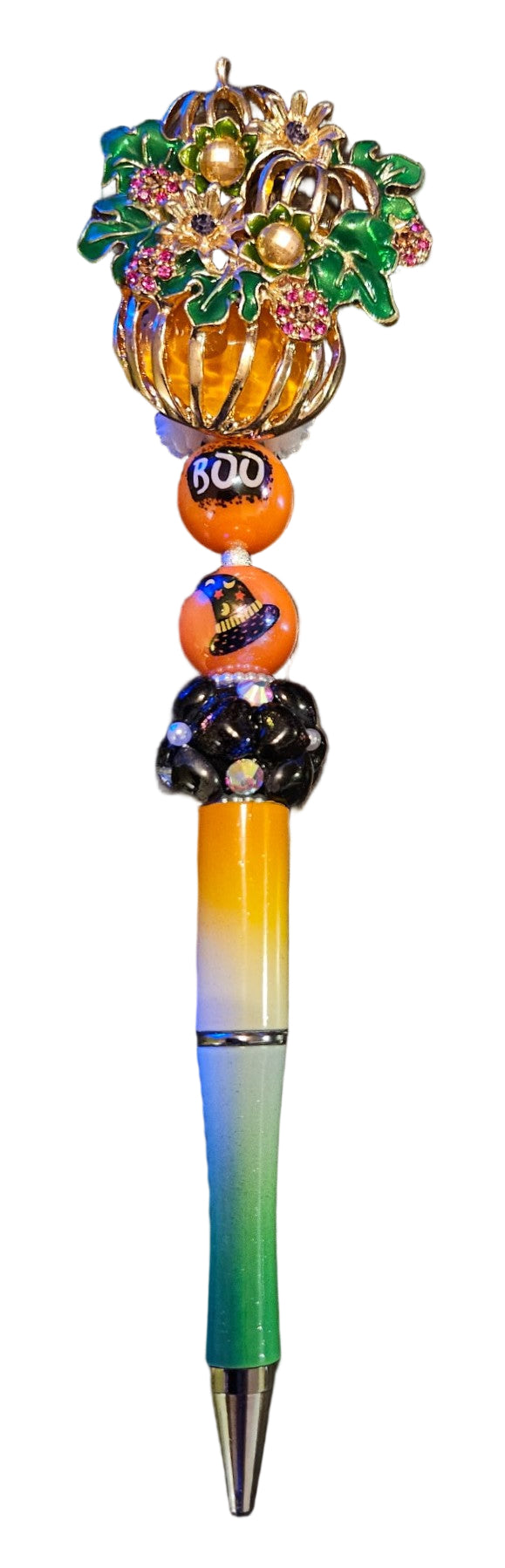 Colorful pumpkin pen with decorative top.